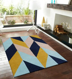 Modern geometric chevron zigzag pattern rug in blue, yellow, and beige on wooden floor in bright living room