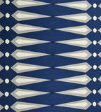 Modern geometric rug with navy blue base and white and gray angular patterns from Mannat Rugs