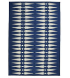 Modern geometric rug with navy blue background and white diamond-shaped pattern by Mannat Rugs