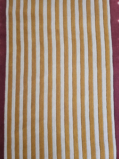 Striped fabric with brown and white stripes with a pink border