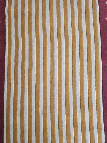 Striped fabric with brown and white stripes with a pink border