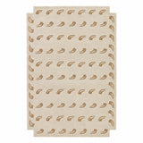 A rectangular area rug in a light beige or cream tone with a repeating pattern of small brown leaf or vine motifs, shown flat against a plain white background.