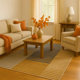 Modern living room with striped gradient rug, beige sofa and armchair, wooden coffee table, autumn decor