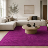 Modern living room with a purple rug, beige sofa, and wooden coffee table.