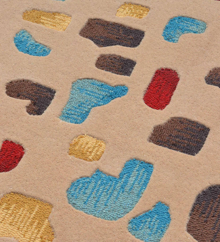 Luxury artisan rug in beige with vibrant red, turquoise, and mustard accents