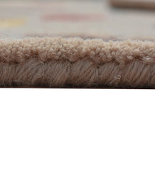 Eclectic wool rug in beige with modern patch-style motifs