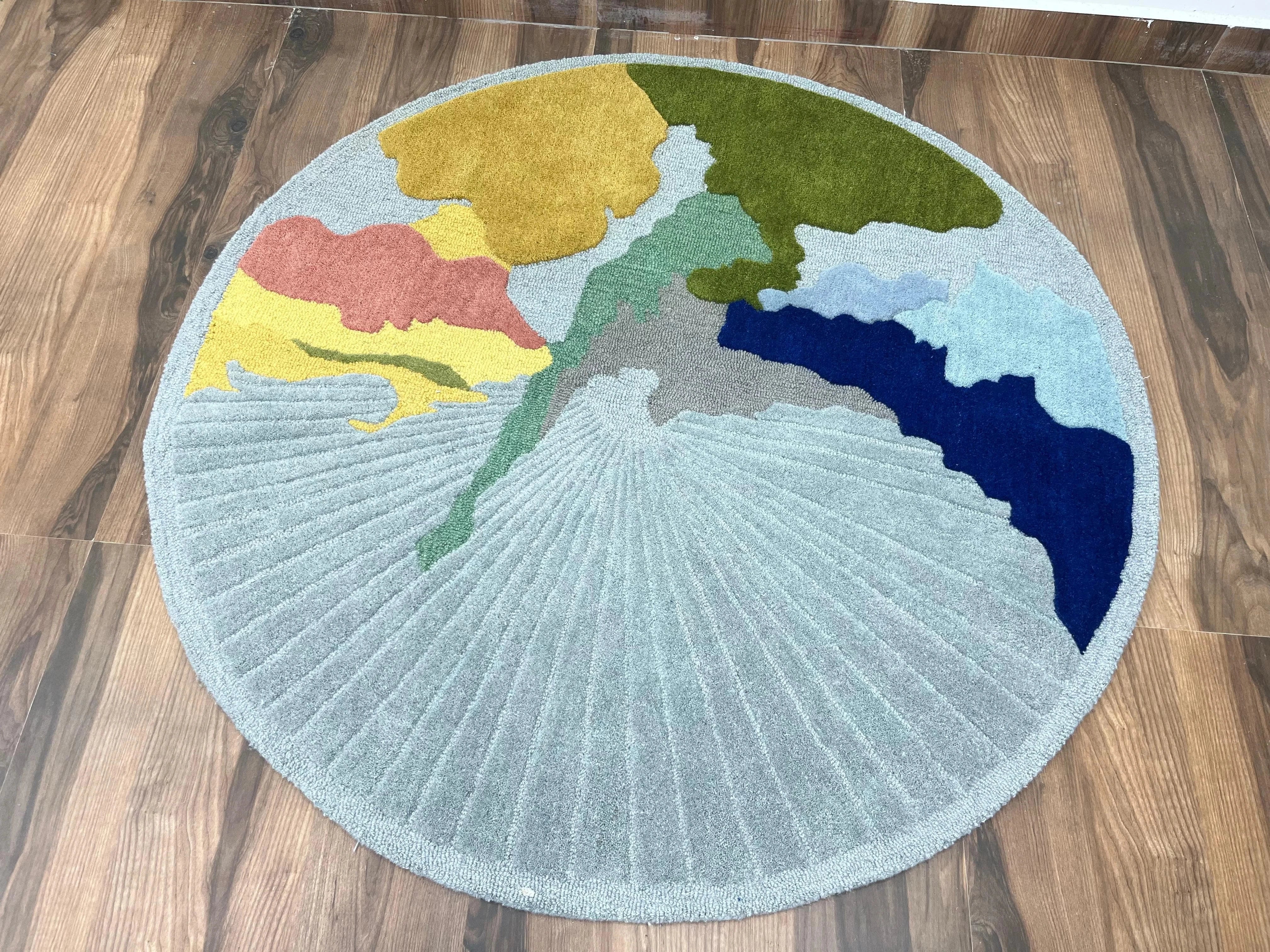 Modern artistic circular rug with pastel and bold tones.