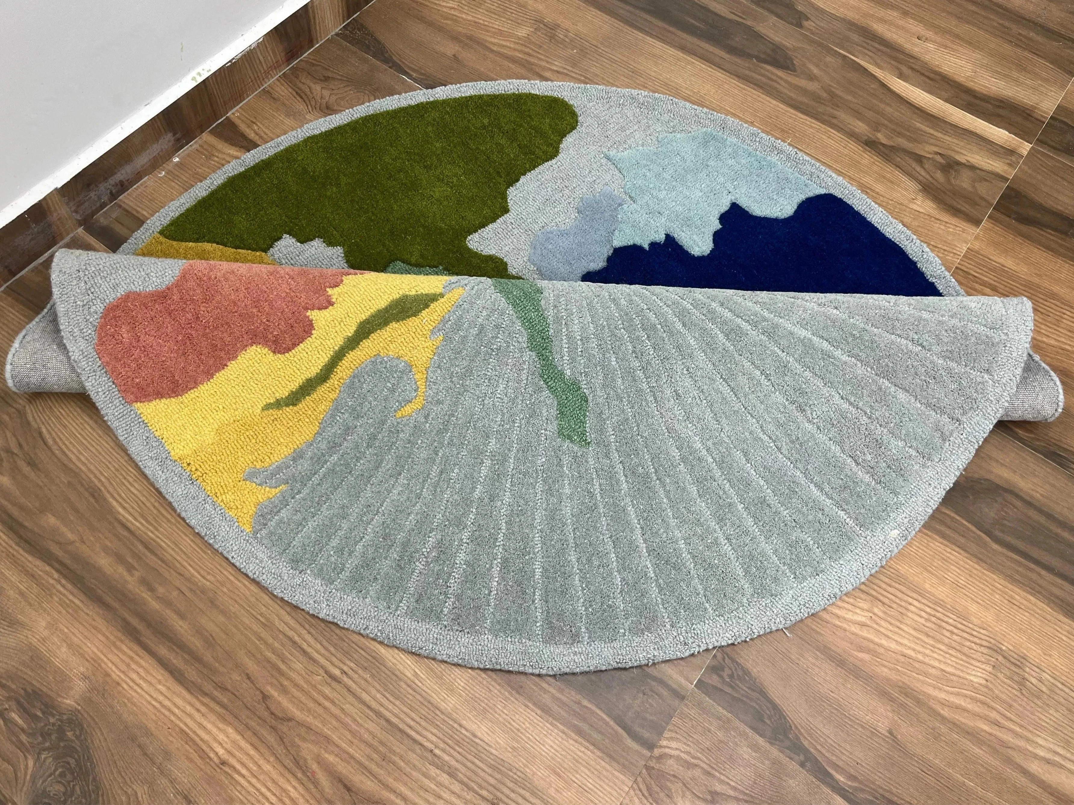 Contemporary round wool rug for living room decor.