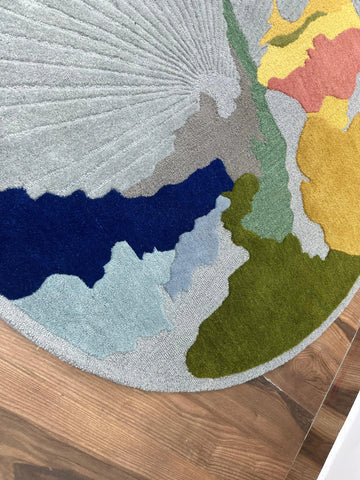 Luxury hand-tufted rug with grey, blue, mustard, and olive accents.