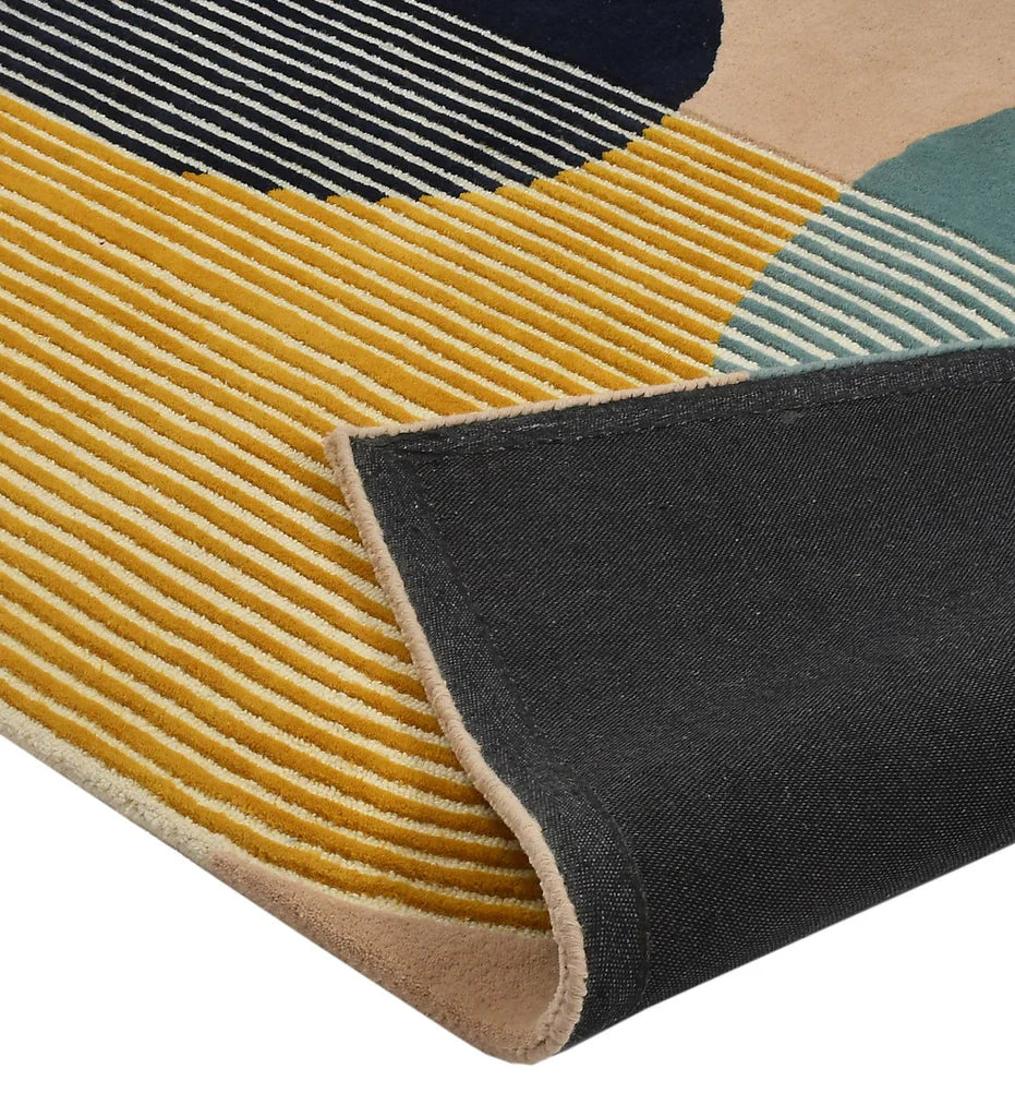 Hand-tufted wool area rug with colorful arched geometric lines in teal, mustard, white, black, and beige.