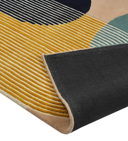 Hand-tufted wool area rug with colorful arched geometric lines in teal, mustard, white, black, and beige.