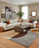 Multicolor modern geometric abstract hand-tufted area rug styled in a living room, adding a bold, contemporary, and artistic focal point