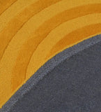 Close-up of mustard yellow circular pattern modern rug with textured fabric and stitched edge