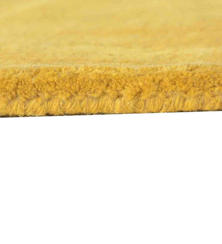 Hand-tufted wool rug with modern concentric design in golden yellow