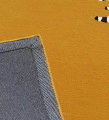 Contemporary geometric wool rug with mustard top and striped design.