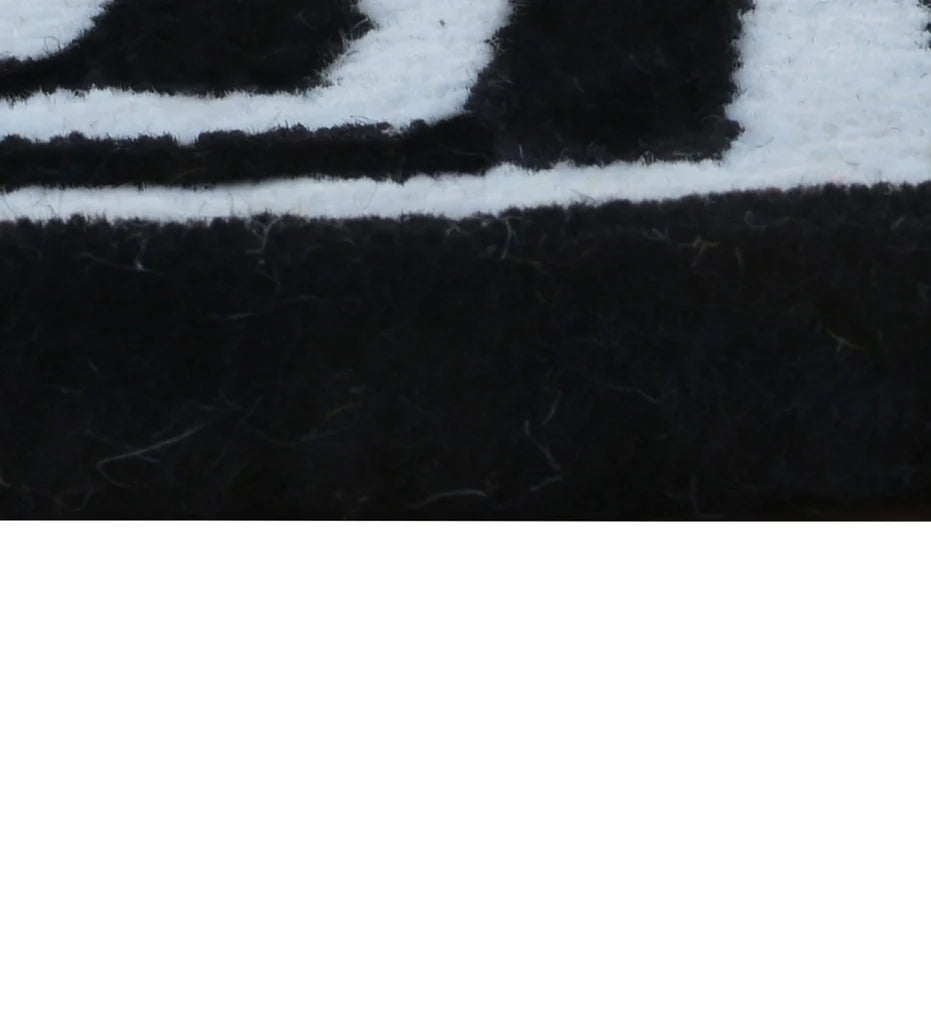 Designer hand-tufted rug combining mustard yellow and monochrome patterns.