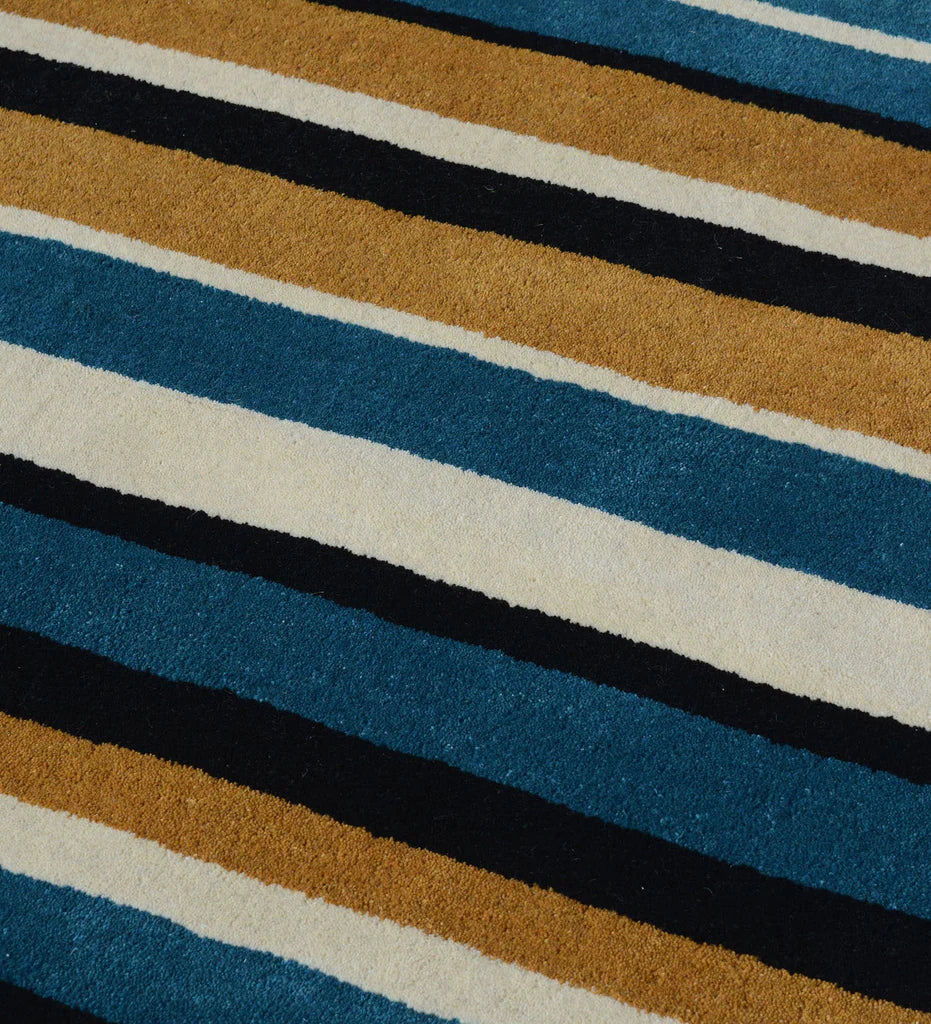 Modern hand-tufted area rug with bold multi-color vertical stripe design.