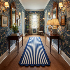 Navy blue and ivory scalloped border hand tufted runner rug placed in an entryway for modern interior styling