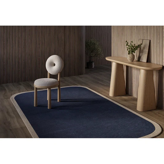 Blue and cream hand tufted wool area rug in living room