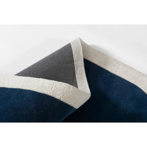 Bold navy blue with cream border hand tufted rug