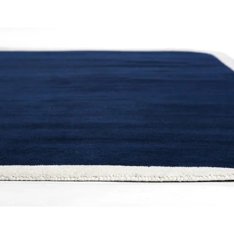 Pile thickness of Hand-tufted navy blue wool area rug with cream border – modern rectangular carpet for living room or bedroom