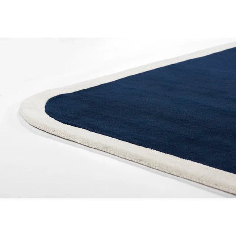 Navy blue rug with cream border