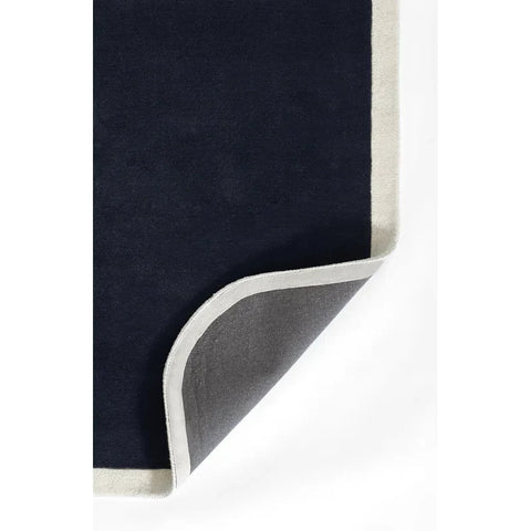 Navy blue and cream bordered hand tufted solid rug