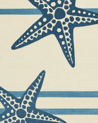 Coastal striped rug with navy starfish motifs