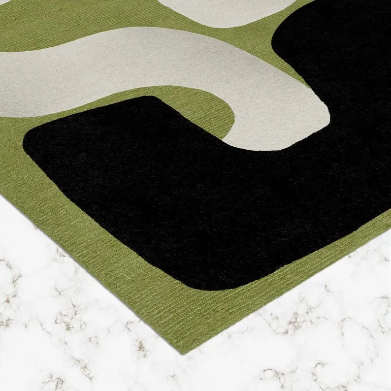 Contemporary abstract area rug with black, white, and green tones.