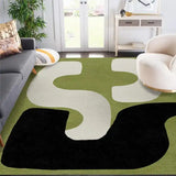 Modern abstract geometric rug with olive green, black, and cream shapes in stylish living room
