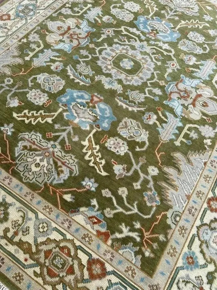 Olive green wool area rug with traditional medallion patterns