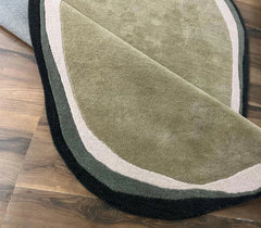 Nature-inspired olive green rug with layered neutral borders.