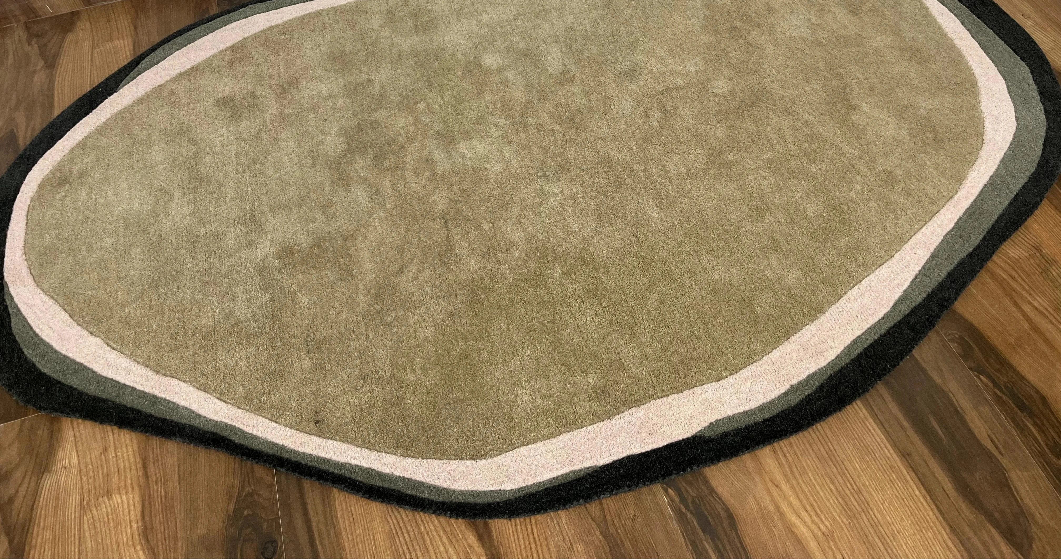 Modern artisan rug with free-form design and earthy tones.