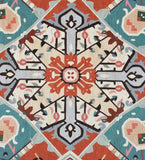 Close-up of luxury handwoven orange and turquoise Serapi rug with intricate geometric floral pattern