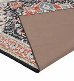 Traditional handwoven orange Serapi rug with intricate floral and geometric patterns, corner flipped to show beige backing