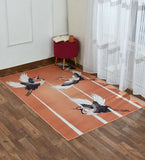 Peach-toned luxury rug with flying cranes design on wood floor near red stool and sheer white curtains