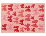 Blush holiday rug decorated with red and pink bows.