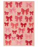 Pink Christmas rug with hand-tufted bow pattern design.