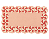 Blush pink holiday rug featuring candy swirl design.