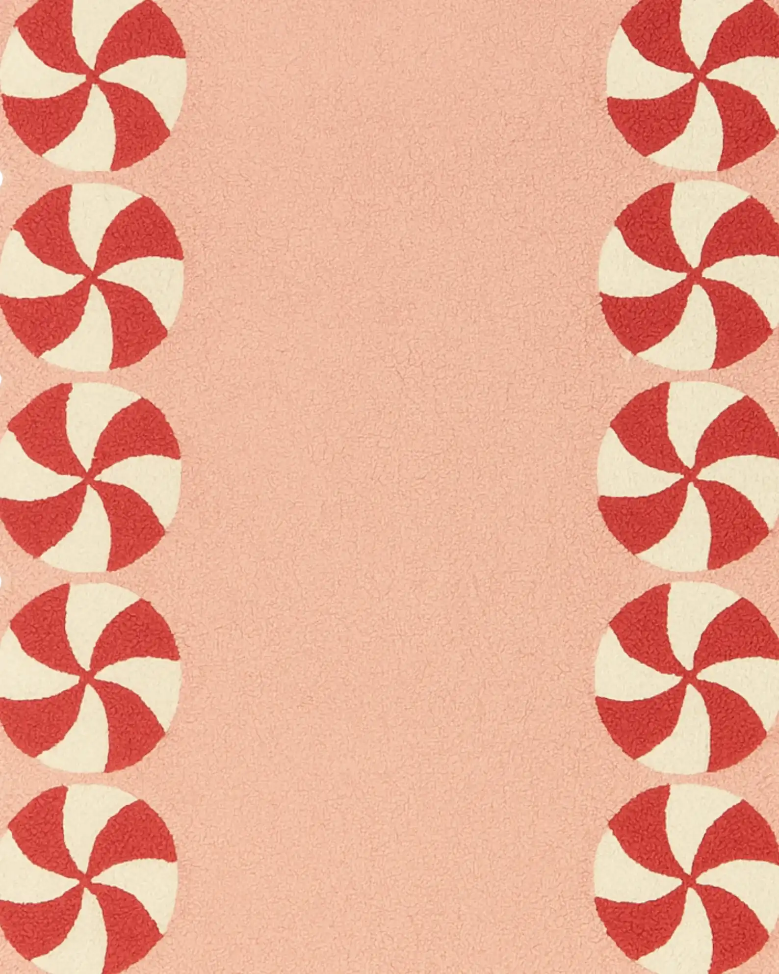 Pink wool Christmas rug with scalloped peppermint edges.