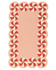 Hand-tufted pink Christmas rug with red peppermint border.