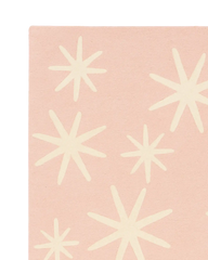 Soft pink wool rug with cream starburst accents for Christmas styling