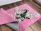 Pink background rug featuring a black and white leopard.