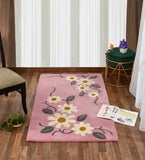 Playful pink rug featuring daisy flowers and green leaves