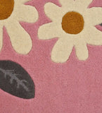 Luxury wool rug with floral daisy design on pink background