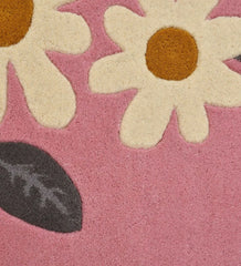 Luxury wool rug with floral daisy design on pink background