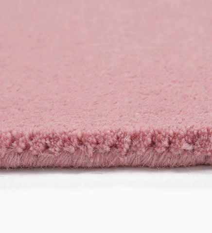 Soft pink hand-tufted rug for nursery or bedroom decor
