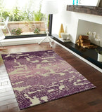 Modern living room with purple and beige abstract gradient textured area rug on hardwood floor
