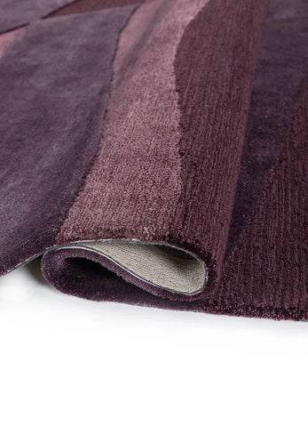 Close-up of a textured purple hand tufted rug