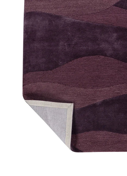 Close up of modern plum wave patterned texture rug with shades of purple
